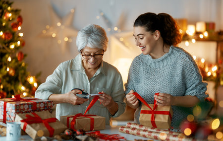 Merry Christmas and Happy Holidays. Cheerful pretty women preparing  presents.の写真素材