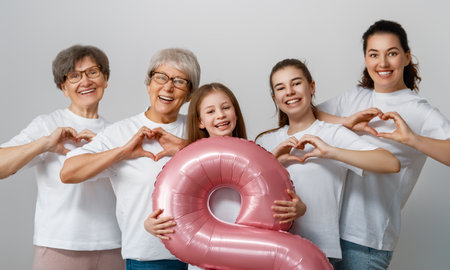 Happy day. Children daughters, mother and grandmothers with air balloon. Family holiday and togetherness. Concept of International Women's Day.の写真素材