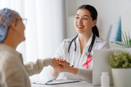 Colour ribbon for concept of illness awareness. Female patient listening to doctor in medical office. Raising knowledge on people living with disease.の写真素材