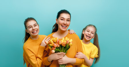 Happy day. Children daughters are congratulating mother. Family holiday and togetherness. Concept of International Women's Day.の写真素材