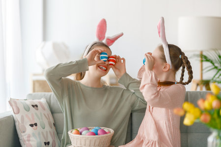 Cute little children wearing bunny ears on Easter day. Girls with painted eggs.の写真素材
