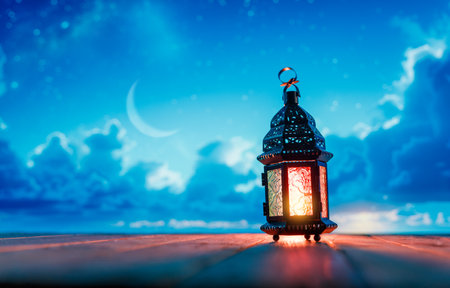 Ornamental Arabic lantern with burning candle glowing at night. Festive greeting card, invitation for Muslim holy month Ramadan Kareem.の写真素材