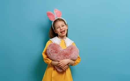 Cute little child wearing bunny ears on Easter day.