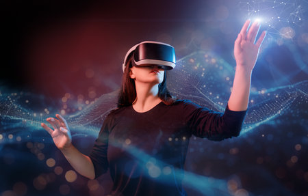 Metaverse technology concept. Woman with VR virtual reality goggles. Futuristic lifestyle.の写真素材