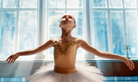 Cute little girl dreaming of becoming a ballerina. Child girl in a tutu dancing in the ball room. Baby girl is studying ballet.の写真素材