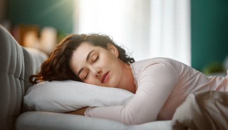 A beautiful young woman is sleeping in the bedroom at home.の写真素材