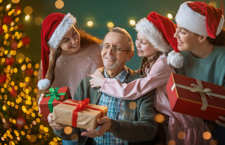 Merry Christmas and Happy Holidays. Grandpa, mum and children exchanging gifts. Parents and...