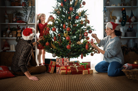 Merry Christmas, Happy Holidays. Mom, dad and daughter near the tree indoors. The morning before Xmas.の写真素材