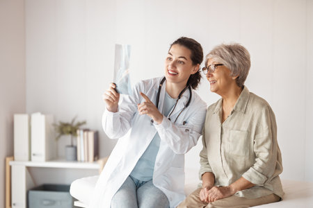 Female patient listening to a doctor in hospital.の写真素材