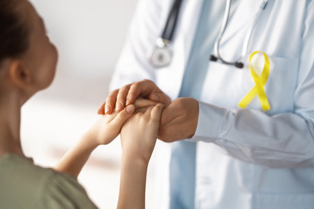 World Childhood cancer Day. Girl patient listening to a doctor in medical office.の写真素材