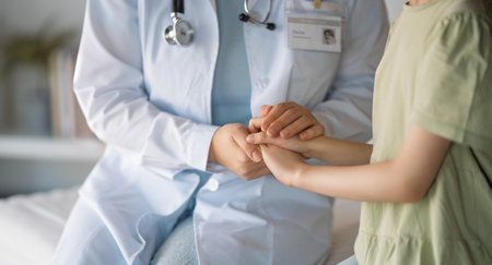 World Childhood cancer Day. Girl patient listening to a doctor in medical office.の写真素材