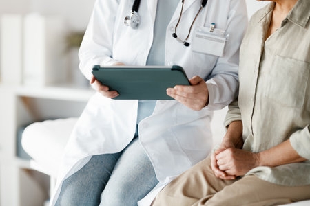 Female patient listening to a doctor in hospital.の写真素材