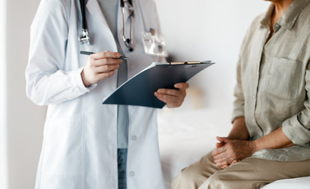Female patient listening to a doctor in hospital.の写真素材
