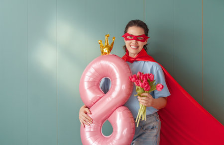 Beautiful young woman with a balloon in the shape of an eight. Concept of International Women's Day.の写真素材