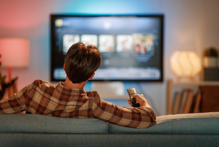 Person watching  TV, movies . Man spending time at home.