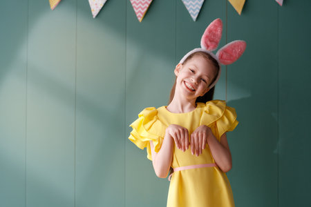 Cute little child wearing bunny ears on Easter day.の写真素材