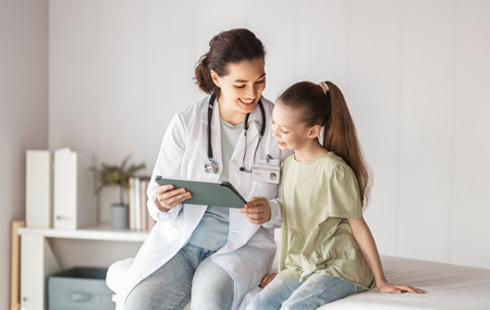 Girl patient listening to a doctor in medical office.の写真素材