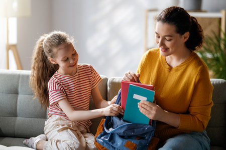Happy family preparing for school. Little girl with mother.の写真素材