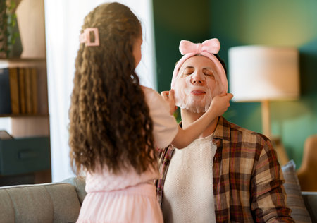 Funny family! Father and his child daughter with a face mask.の写真素材