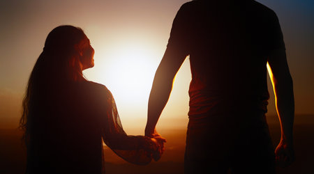 Happy loving family. A father and his child daughter watching the sunsetの写真素材