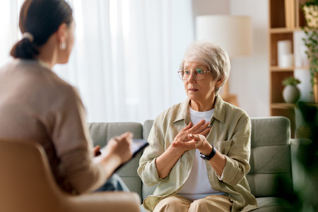 Consultation of senior female patient on reception for psychologist.の写真素材