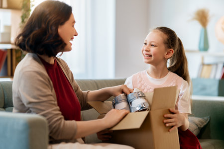Mother and daughter are unpacking cardboard. Concept of online shopping.の写真素材