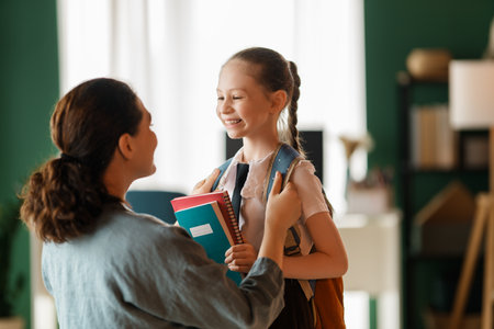 Happy family preparing for school. Little girl with mother.の写真素材