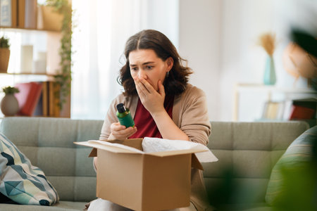 Woman is unpacking cardboard. Concept of frustrated online shopping.の写真素材