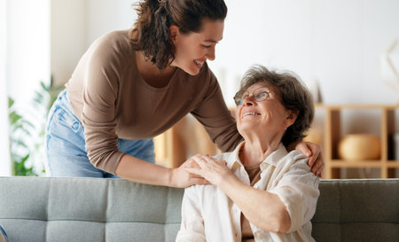 Happy patient and caregiver spending time together. Senior woman and her adult daughter.の写真素材