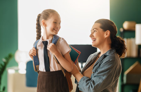 Happy family preparing for school. Little girl with mother.の写真素材