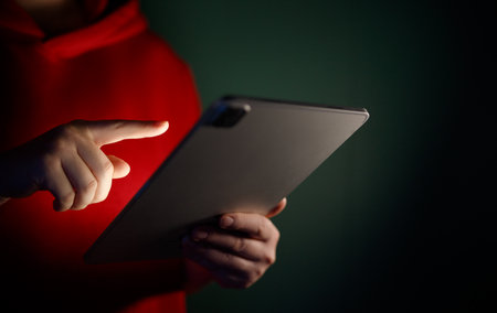 Woman is using tablet pc. Computer and hands close up.の写真素材