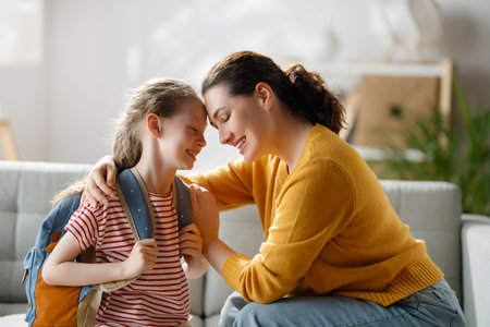 Happy family preparing for school. Little girl with mother.の写真素材