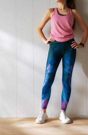 Healthy lifestyle and sport concepts. Woman in fashionable sportswear is doing exercise.