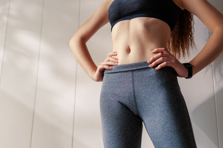 Fitness athlete close-up. Healthy lifestyle and sport concepts. Woman in fashionable sportswear.の写真素材