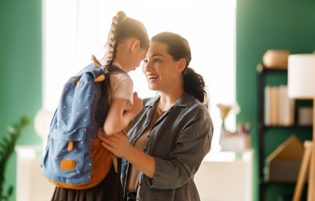 Happy family preparing for school. Little girl with mother.