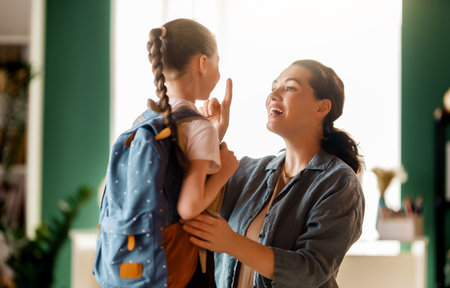 Happy family preparing for school. Little girl with mother.
