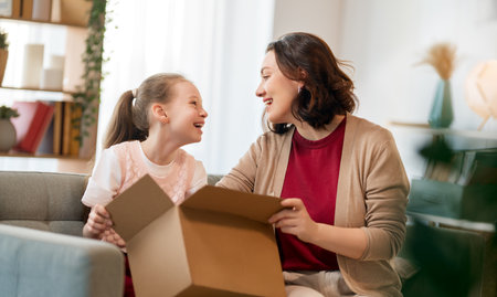 Mother and daughter are unpacking cardboard. Concept of online shopping.の写真素材