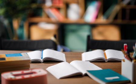 Workbooks and pencils on desk in classroom
