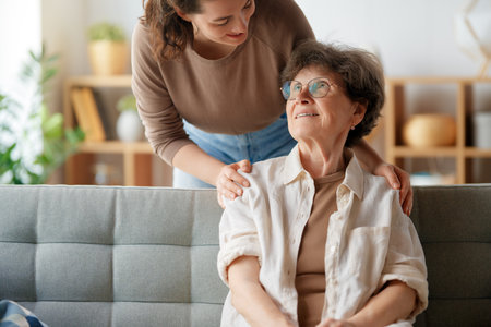 Happy patient and caregiver spending time together. Senior woman and her adult daughter.