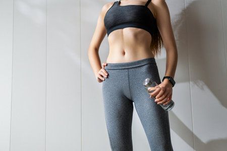 Fitness athlete close-up. Healthy lifestyle and sport concepts. Woman in fashionable sportswear.