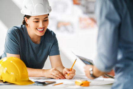 Team of architects working on plans at construction site.