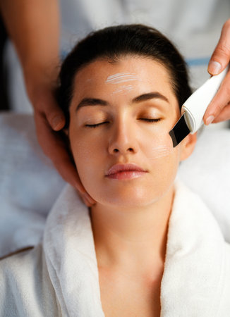 Facial treatment in spa salon. Skin care and massage. Cosmetologist at workの写真素材