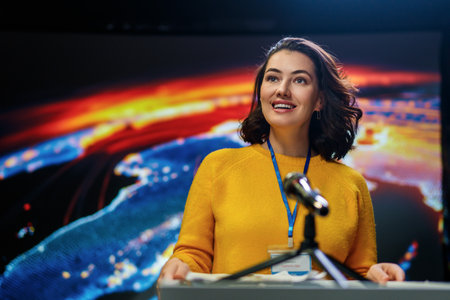 A young woman is giving a presentation at a conference.の写真素材