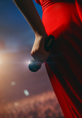 A singer performing on stage with a microphone in front of bokeh-style lanterns, close up.の写真素材