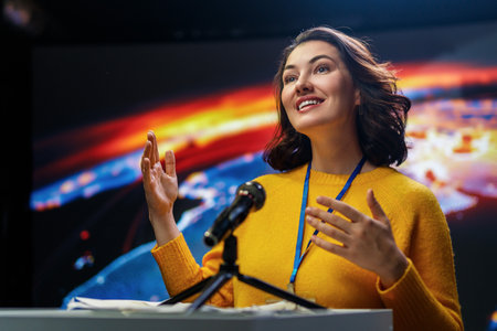 A young woman is giving a presentation at a conference.の写真素材