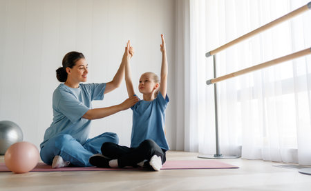 The child is undergoing physical therapy. The girl is doing exercises under the doctor's supervision.の写真素材