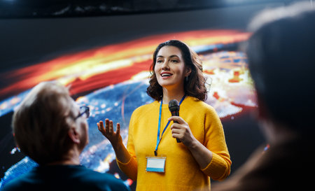 A young woman is giving a presentation at a conference.の写真素材