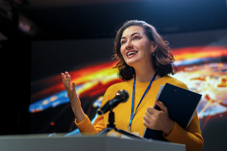 A young woman is giving a presentation at a conference.の写真素材