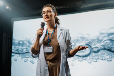 A woman is giving a presentation at a conference on care products.の写真素材