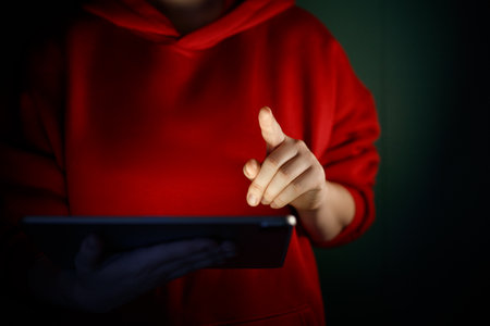 Woman is using tablet pc. Computer and hands close up.の写真素材